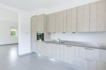 Light wood kitchen with white walls