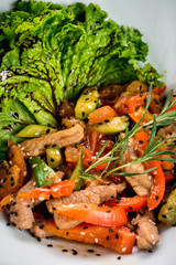 Salad from meat with red pepper and soy sauce on wooden background