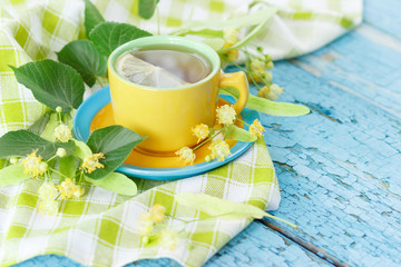 Cup of herbal tea with linden blossoms and lemon