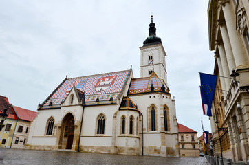 Fototapeta na wymiar ZAGREB, CROATIA -June 9, 2016 : Church of St.Mark in St.Mark's Square in Zagreb, Croatia in a Cloudy Day