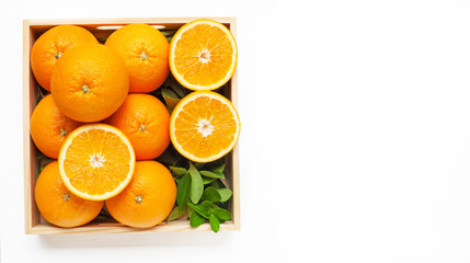 Fresh orange citrus in wooden box isolated on white background.  Top view