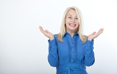 Portrait of happy middle aged woman. Surprised happy woman looking with her mouth open and holding...