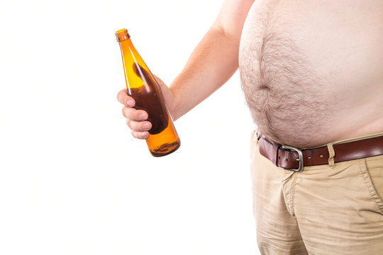 Fat man with big belly holding bottle of beer isolated on white background. Alcohol abuse concept.