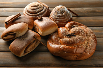 Sweet cinnamon buns on wooden table