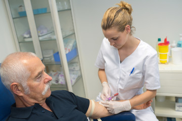nurse giving injection to senior man