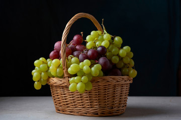 still life of grapes in a basket ripe green red natural holiday