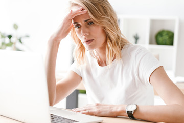 Concetrated businesswoman working on laptop computer