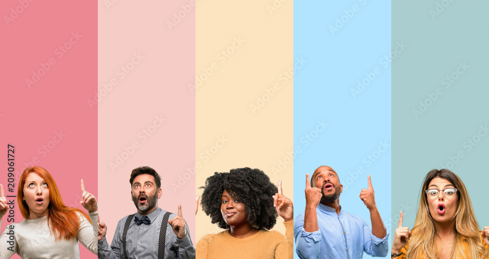 Canvas Prints Cool group of people, woman and man happy and surprised cheering expressing wow gesture pointing up