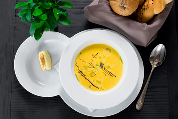 Pumpkin cream soup on wooden background. Top view