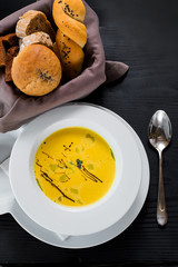 Pumpkin cream soup on wooden background. Top view