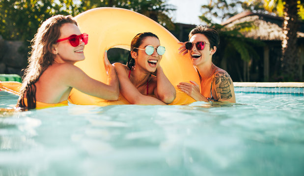 Female friends enjoying summer at pool