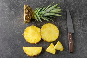 Composition with slices of delicious pineapple on grey background