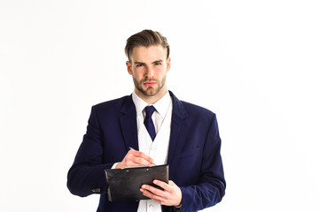 Business documents concept. Man with serious face writes on plan