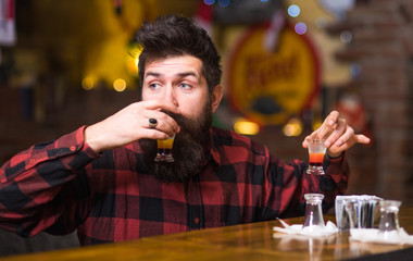 Hipster holds glass with alcoholic drink, short cocktail