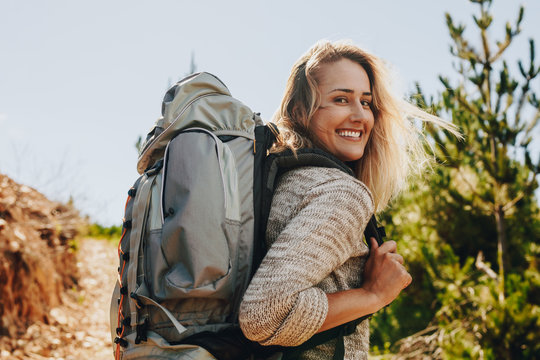 Woman With Backpack Hiking In Nature