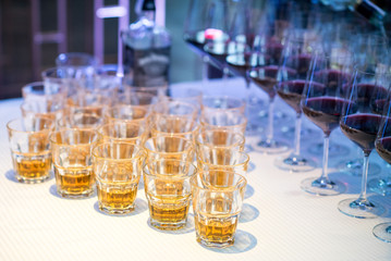 Many glasses woth alcohol on served table at the restaurant