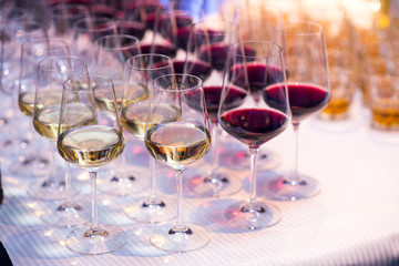 Many glasses woth alcohol on served table at the restaurant