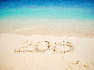 New 2019 year in the South, the sea. Inscription on the sand, celebrate the new year in the tropics. New year holidays