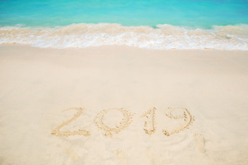 New 2019 year in the South, the sea. Inscription on the sand, celebrate the new year in the tropics. New year holidays