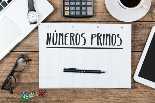 Spanish Text numeros primos (prime numbers) on note pad at office desktop