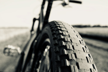 Mountain bike wheel close-up on blurred nature background