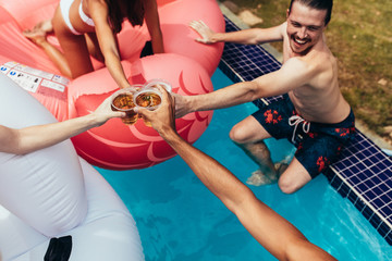 Fototapeta na wymiar Group of friends partying in a pool
