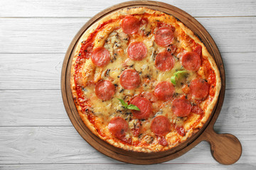 Tasty pepperoni pizza on wooden board