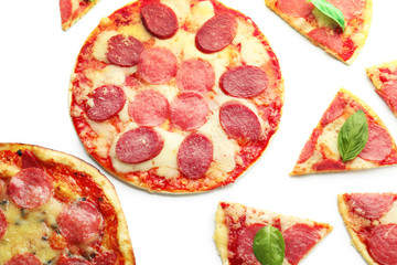 Tasty pepperoni pizza with pieces on white background
