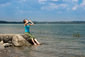 Beautiful young Caucasian woman cooling off in the lake on a summer day in Sapanca, Turkey