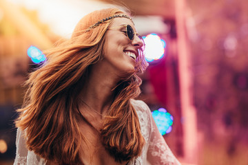 Beautiful hippie woman enjoying at music festival