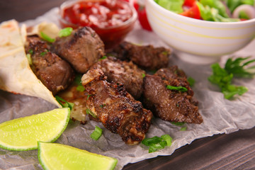 Pieces of shish-kebab on parchment, closeup