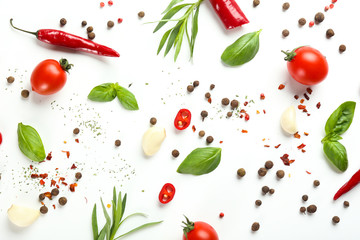 Fresh tomatoes, herbs and spices on white background
