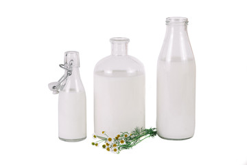 three different bottles of milk with chamomile