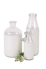 three different bottles of milk with chamomile