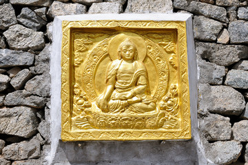 View on Buddha's golden low relief in the lotus position, Leh, district Ladakh - India