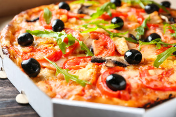 Tasty Italian pizza with olives in box, closeup