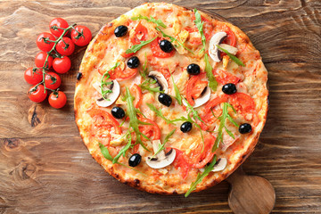 Board with tasty Italian pizza on wooden table