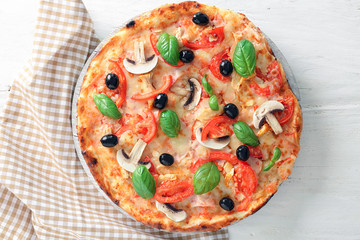 Board with tasty Italian pizza on white wooden table