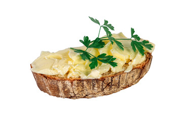 Slice of bread with butter and parsley is isolated on white background