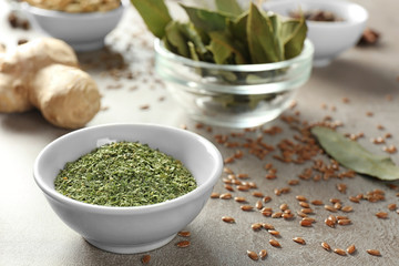 Bowl with dried basil on table