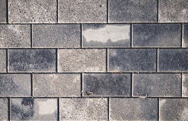 Close up of even horizontally tiled surface with wet stains after rain. Abstract background