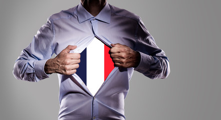 Business man with French flag on gray background - 209069302