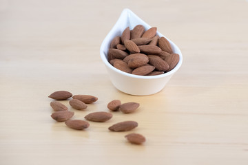 Almonds dried fruit on wooden background