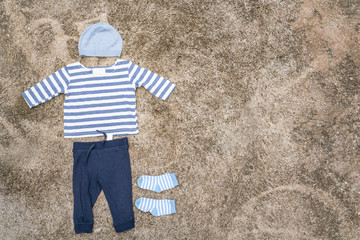 Baby clothes were drying at the clothesline and wooden backdrop