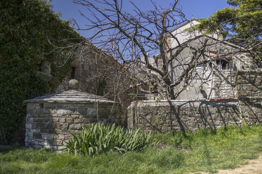 Grisignana, Central Istria, Croatia - Medieval rainwater tank in an old stone house backyard 