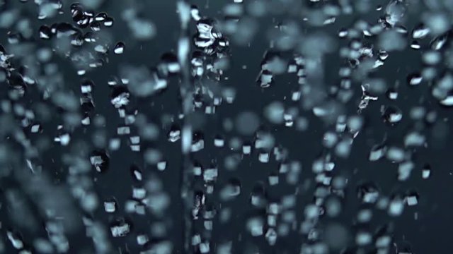 Water drops spurting out against Gray Background