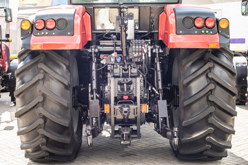 Red tractor with bif black wheels. rear view © Ivan Uralsky