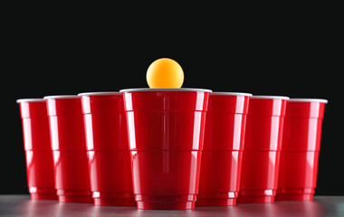 Fototapeta premium Cups and ball for beer pong on table