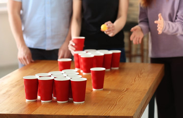 People playing beer pong in bar