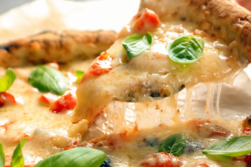 Taking slice of delicious pizza Margherita, closeup